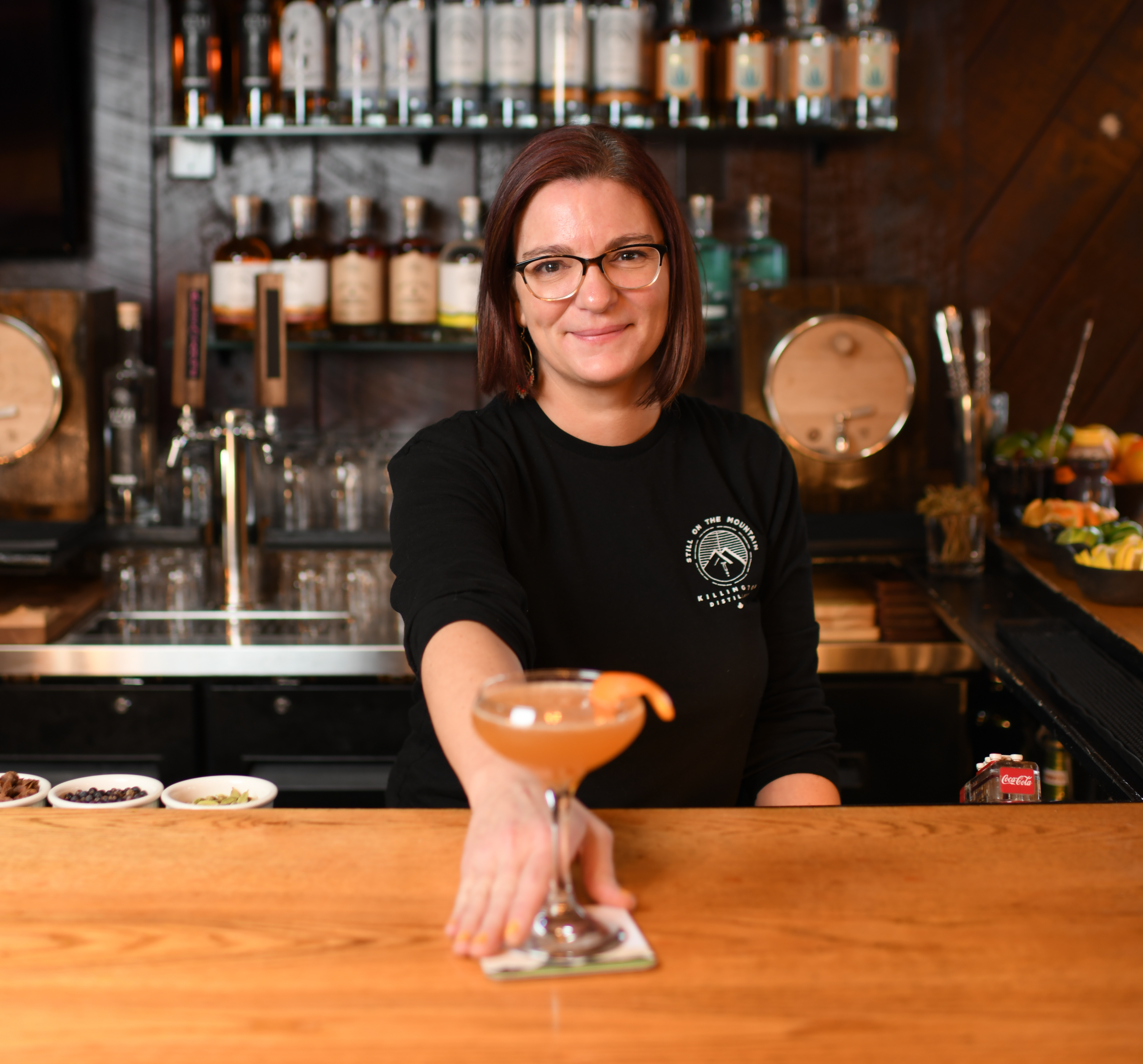 Emily Miner, Bar Manager at Killington Distillery, presents one of their signature spirits.